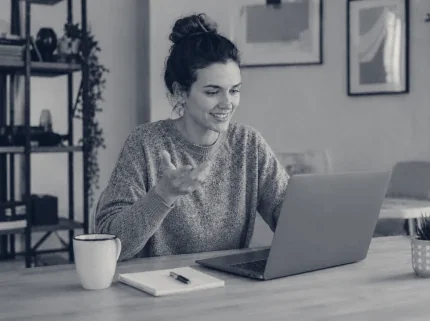A woman talking through her work with Claude on a laptop