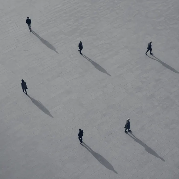 People seen from above, each walking in a different direction