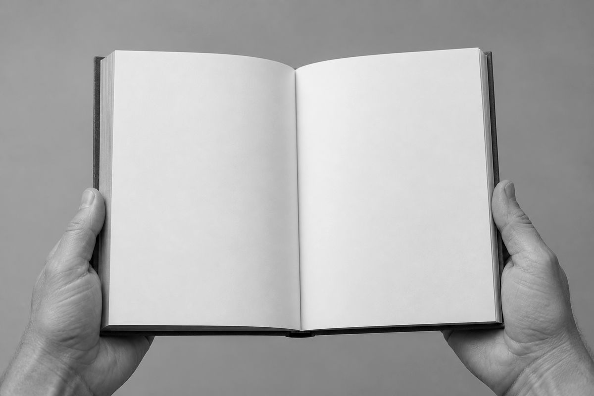 Hands holding an open blank book
