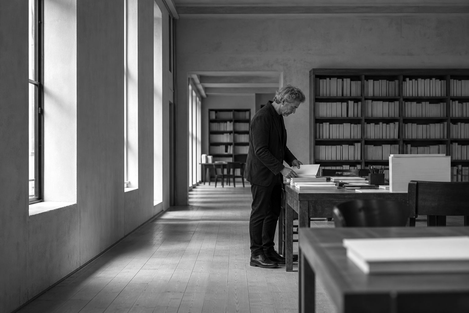 A quiet workroom with manuscripts on the desks