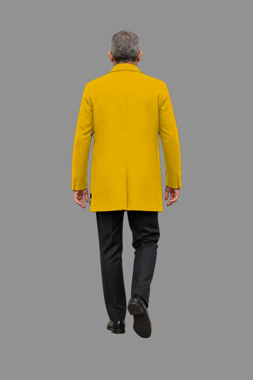 A man in a yellow coat walking away